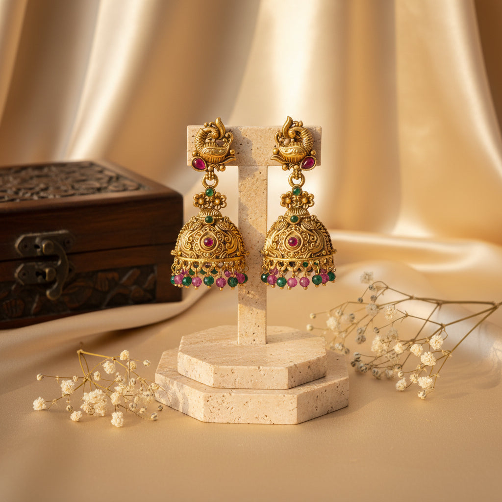 Saranya Antique Gold Peacock Jhumka Earrings with Ruby & Emerald Green Beads